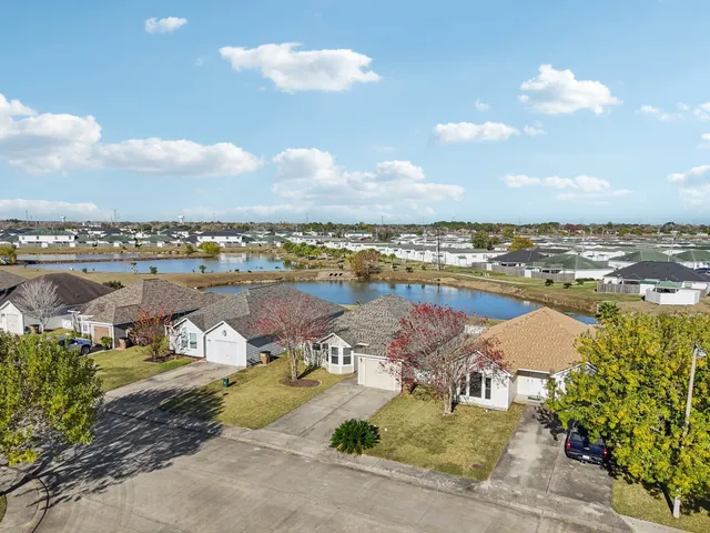 an aerial view of residential houses with outdoor space