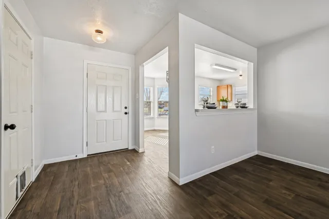 wooden floor in an empty room with a window