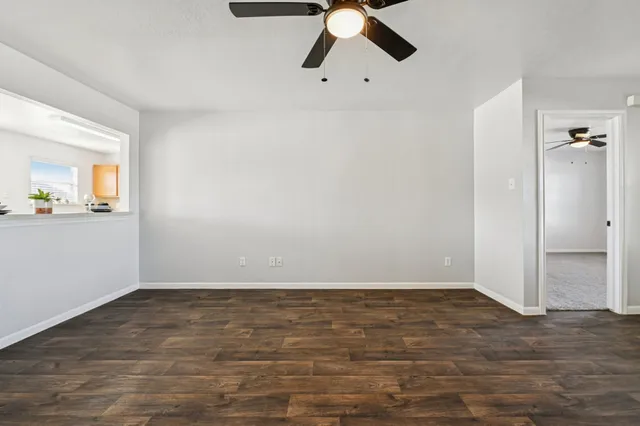 a view of a room with wooden floor and windows