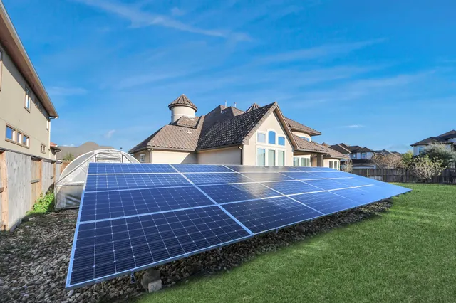 a backyard of a house with table and chairs