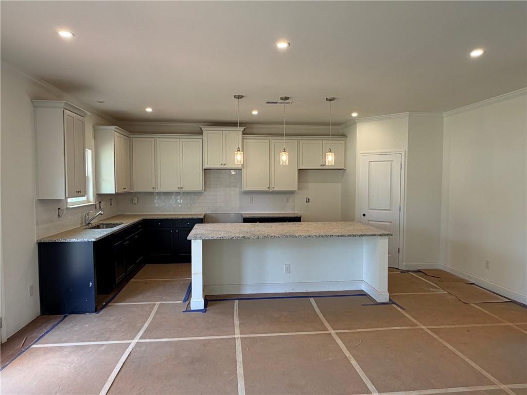 41 Woodland Road Covington, GA 30016 - Photo 4 of 46 a large kitchen with kitchen island a sink stainless steel appliances and cabinets