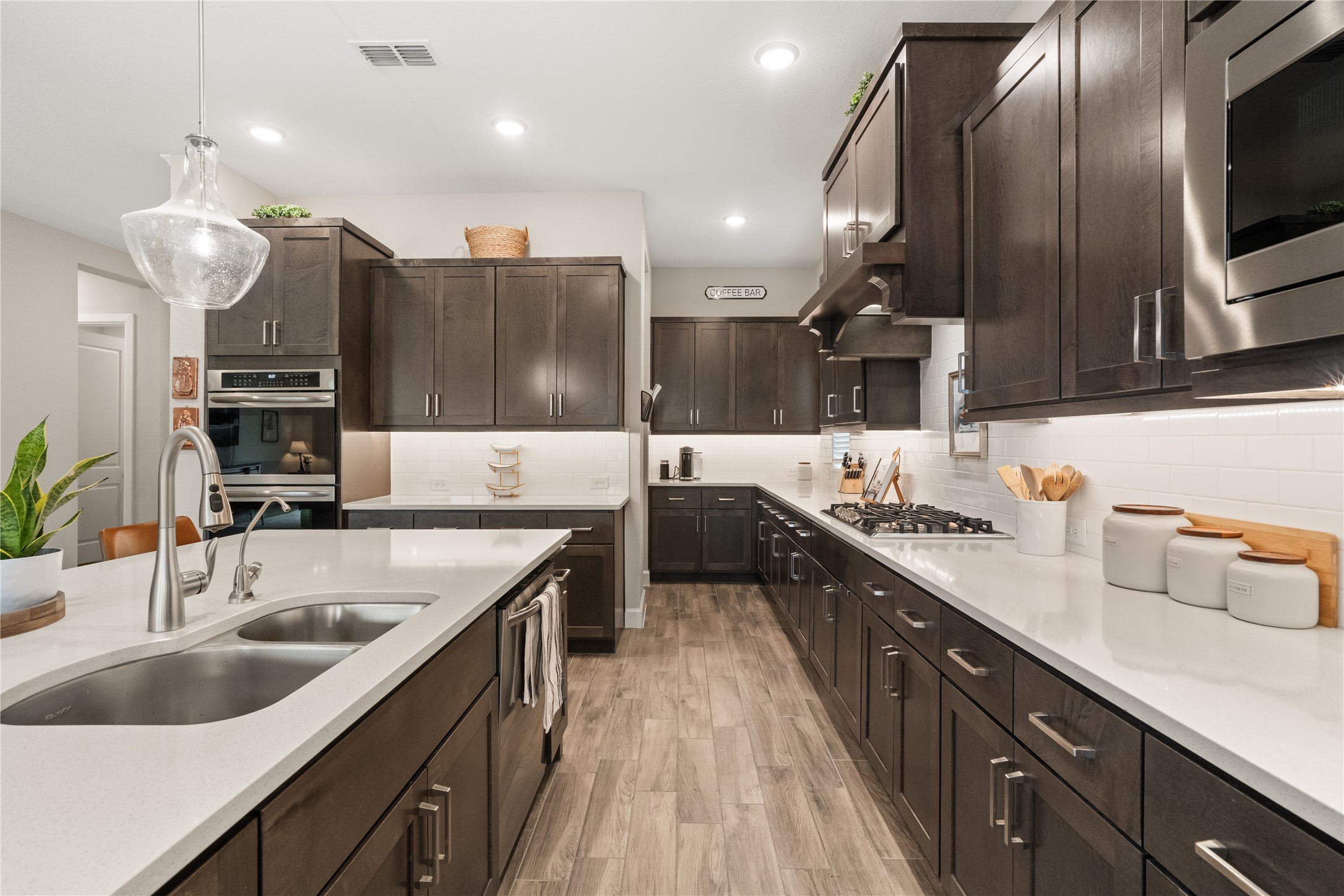 3118 Swift Way Katy, TX 77493 - Photo 4 of 34 Kitchen (Island View) – This expansive island offers seating and additional prep space, complemented by modern finishes and abundant cabinetry.
