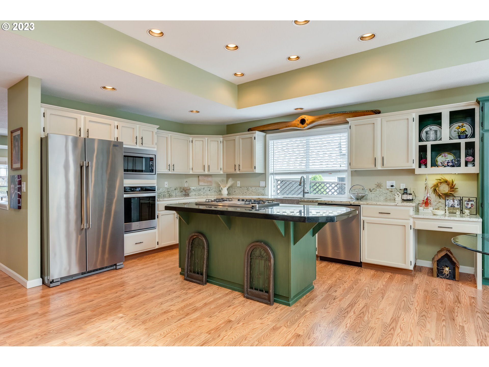 14029 Southeast 35th Loop Vancouver, WA 98683 - Photo 12 of 48 a kitchen with stainless steel appliances granite countertop a refrigerator a sink dishwasher a stove and white cabinets with wooden floor