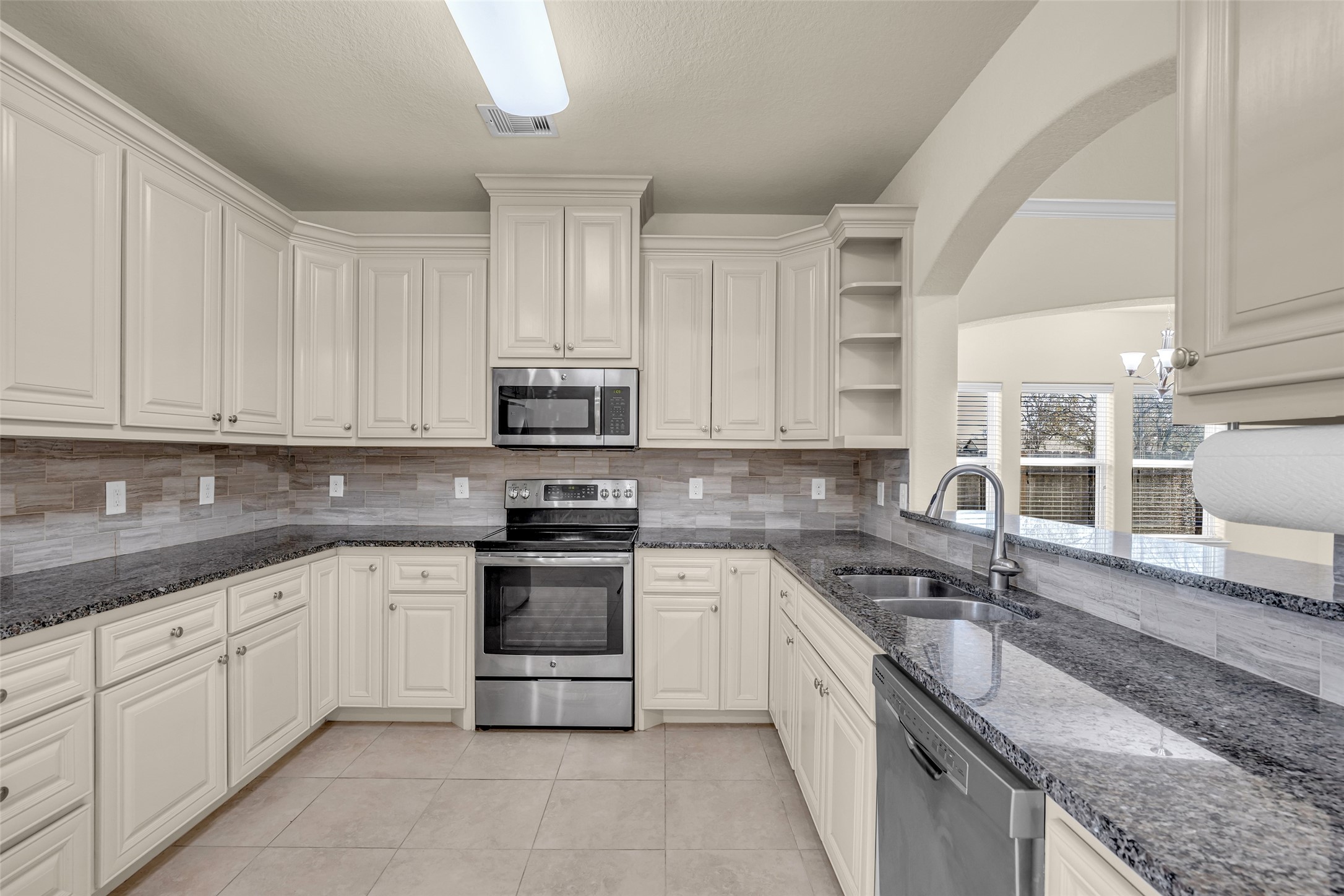 323 Texas Avenue Arcola, TX 77583 - Photo 13 of 27 a kitchen with stainless steel appliances granite countertop a sink and cabinets