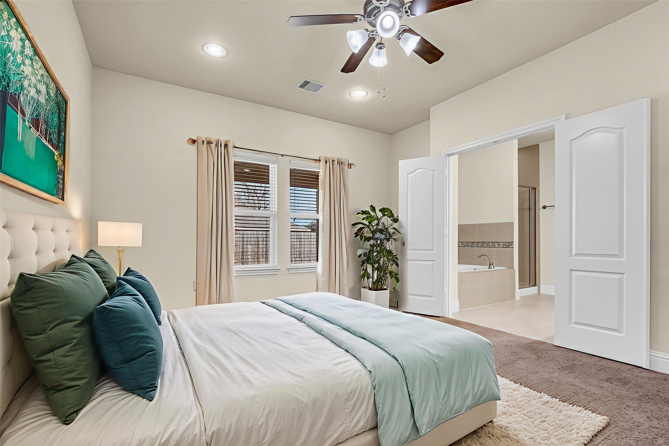 323 Texas Avenue Arcola, TX 77583 - Photo 16 of 27 a spacious bedroom with a large bed and a chandelier