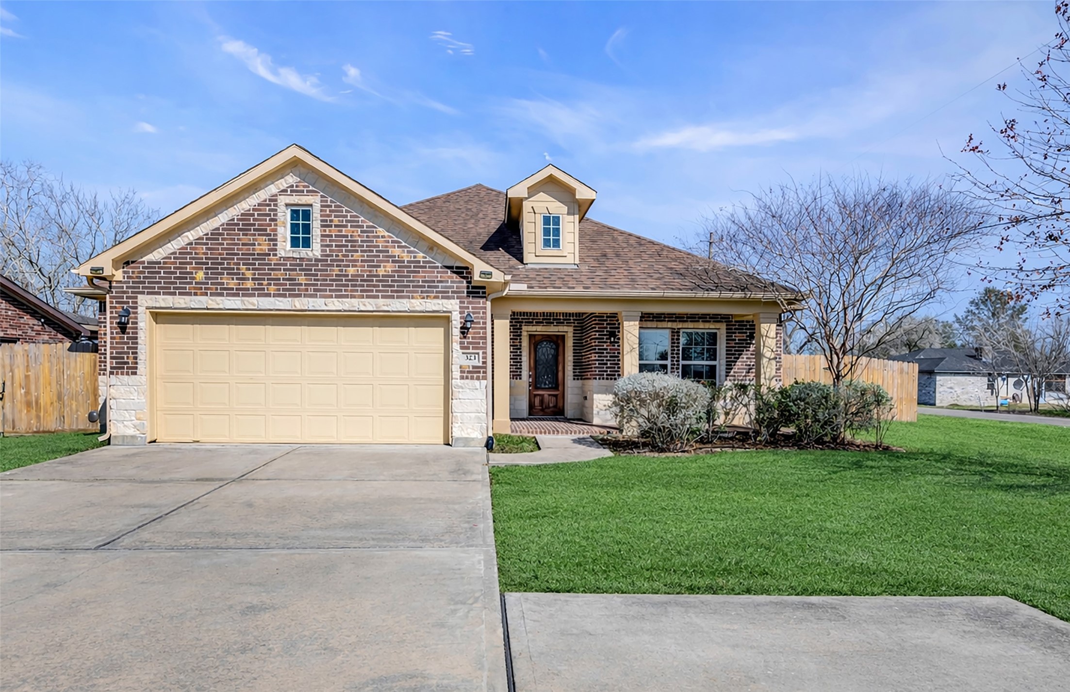 323 Texas Avenue Arcola, TX 77583 - Photo 2 of 27 a front view of a house with a yard and garage
