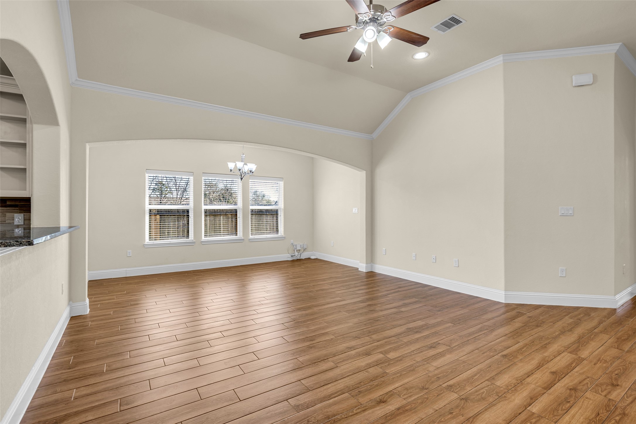 323 Texas Avenue Arcola, TX 77583 - Photo 7 of 27 wooden floor in an empty room with a window