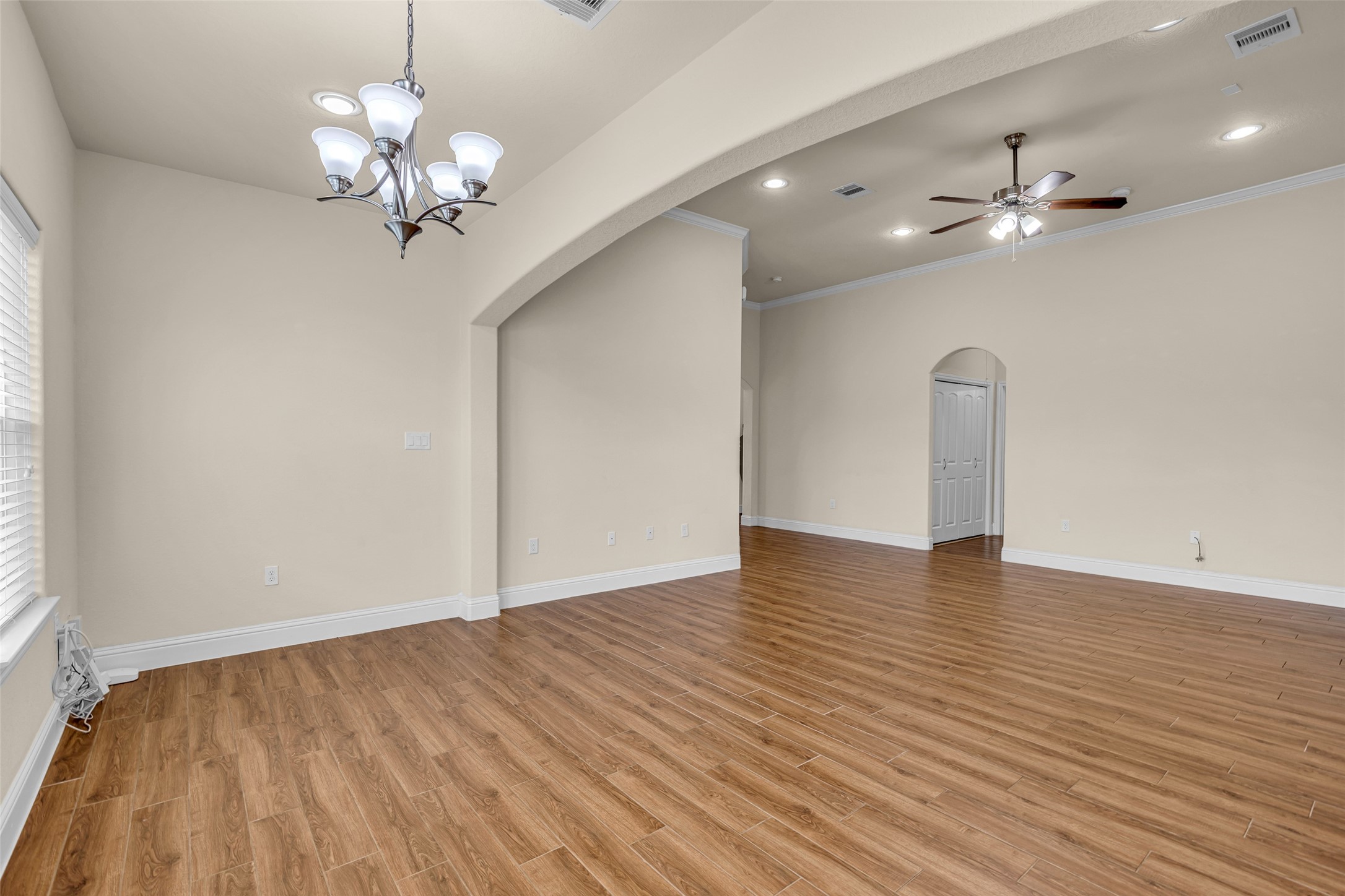323 Texas Avenue Arcola, TX 77583 - Photo 10 of 27 a view of an empty room with wooden floor and a window