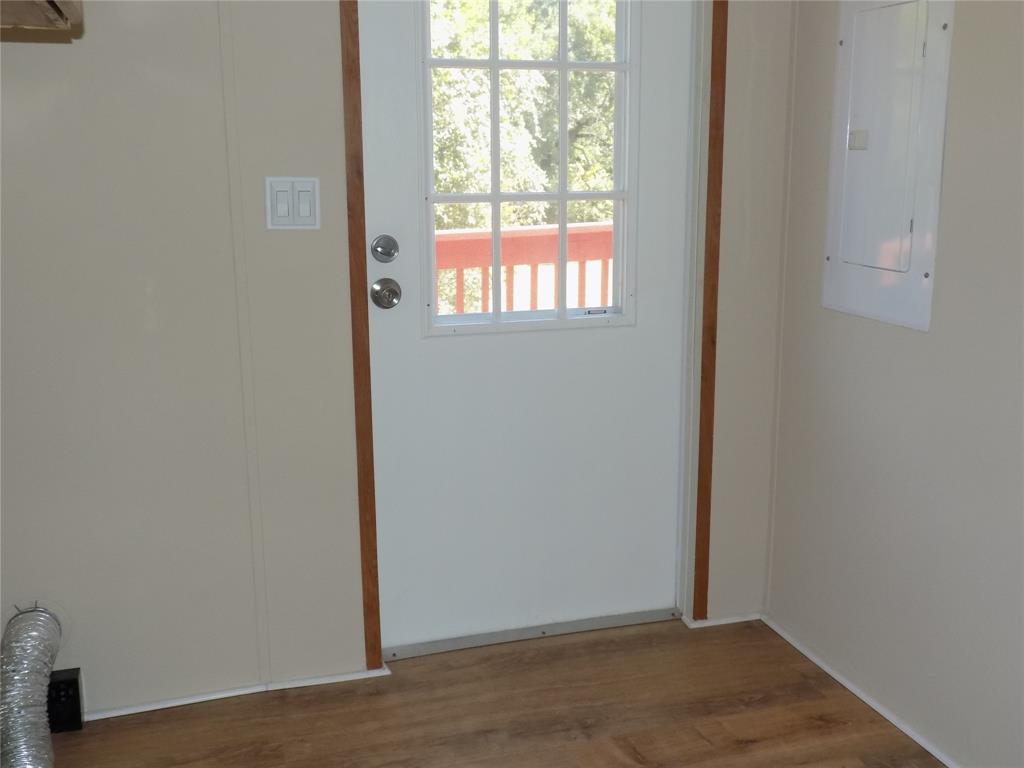 3450 Sarra Lane Springtown, TX 76082 - Photo 13 of 23 Door in laundry room to the outside; panel box handy.