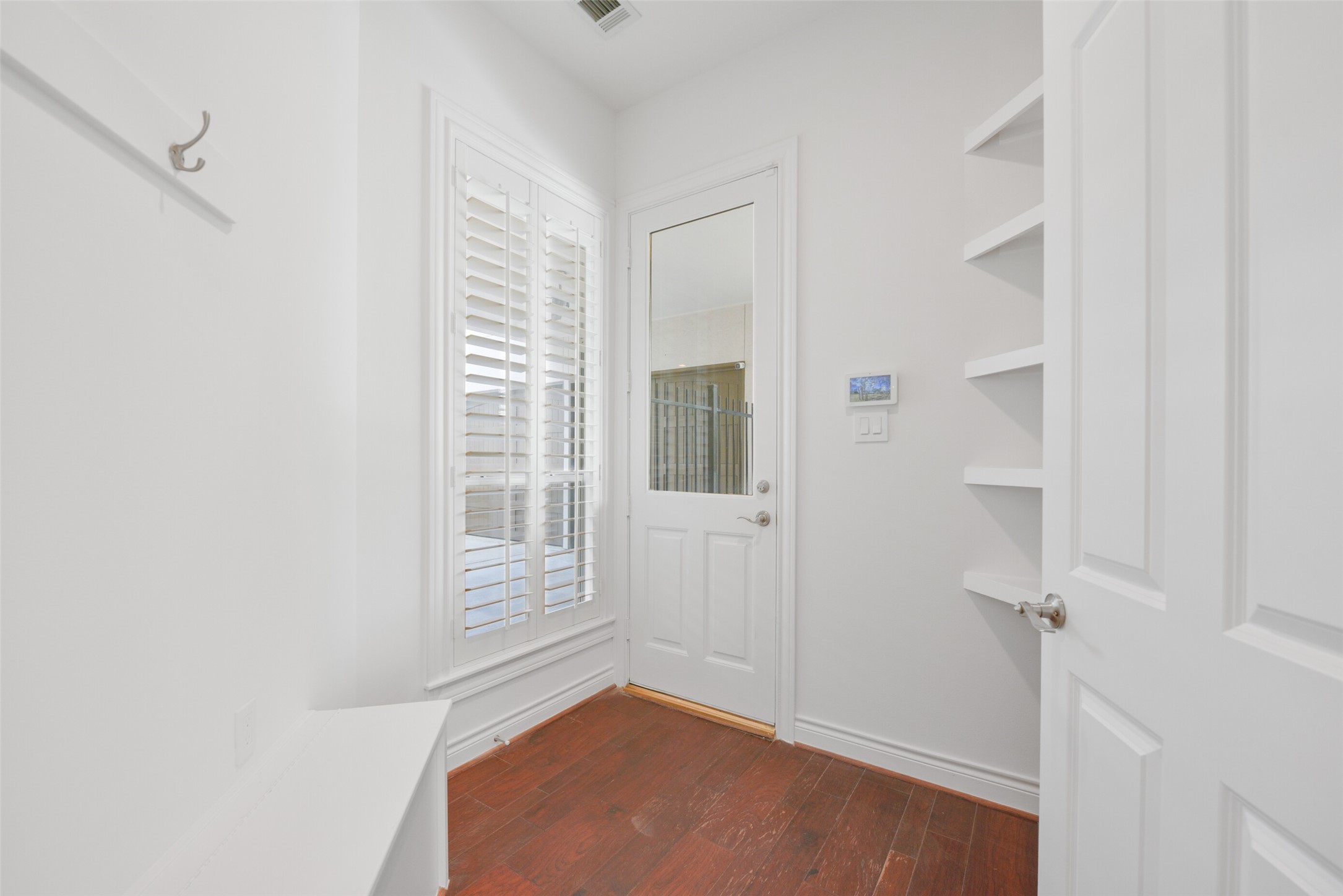 3724 Wroxton Road Houston, TX 77005 - Photo 17 of 40 Coveted mudroom entry with bench, coat hooks, and built-in shelving.