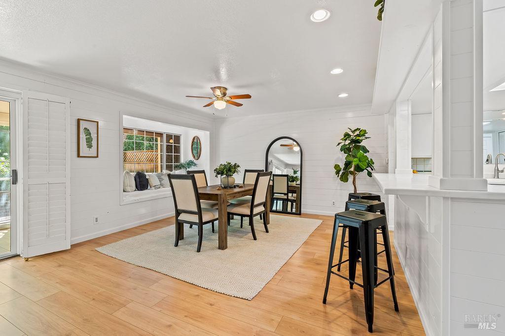 5171 Firestone Place Santa Rosa, CA 95409 - Photo 12 of 48 The dining area is conveniently located just off the kitchen, with an open connection to the main living spaces. A large window fills this cozy nook with natural light and offers peaceful views toward the backyard.