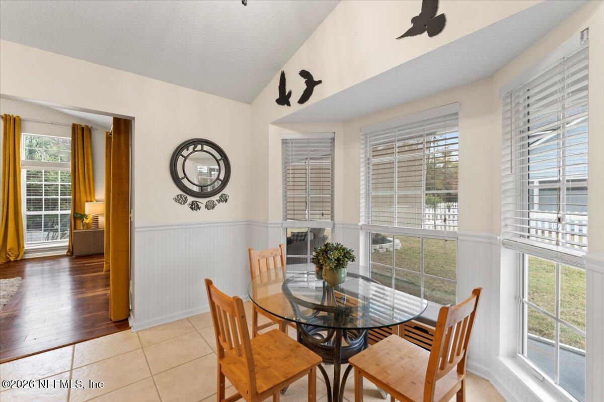 1489 Marshview Court Atlantic Beach, FL 32233 - Photo 12 of 47 a view of a dining room with furniture and a large window
