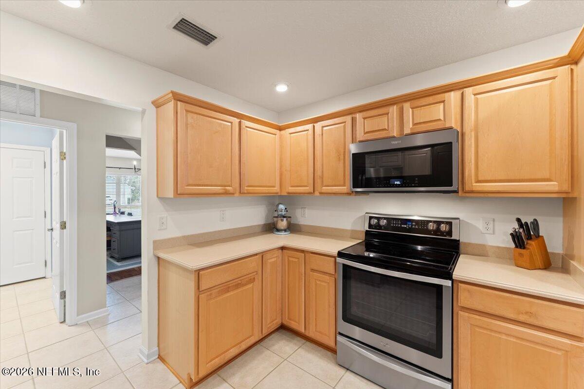 1489 Marshview Court Atlantic Beach, FL 32233 - Photo 16 of 47 a kitchen with stainless steel appliances granite countertop a stove a sink and a microwave