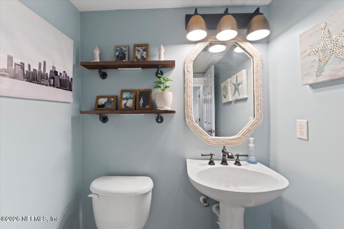 1489 Marshview Court Atlantic Beach, FL 32233 - Photo 17 of 47 a bathroom with a toilet sink and mirror