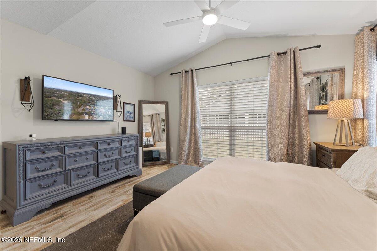 1489 Marshview Court Atlantic Beach, FL 32233 - Photo 19 of 47 a bedroom with a large bed and a flat tv screen on dresser