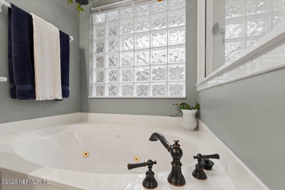 1489 Marshview Court Atlantic Beach, FL 32233 - Photo 22 of 47 a bathroom with a tub and a window