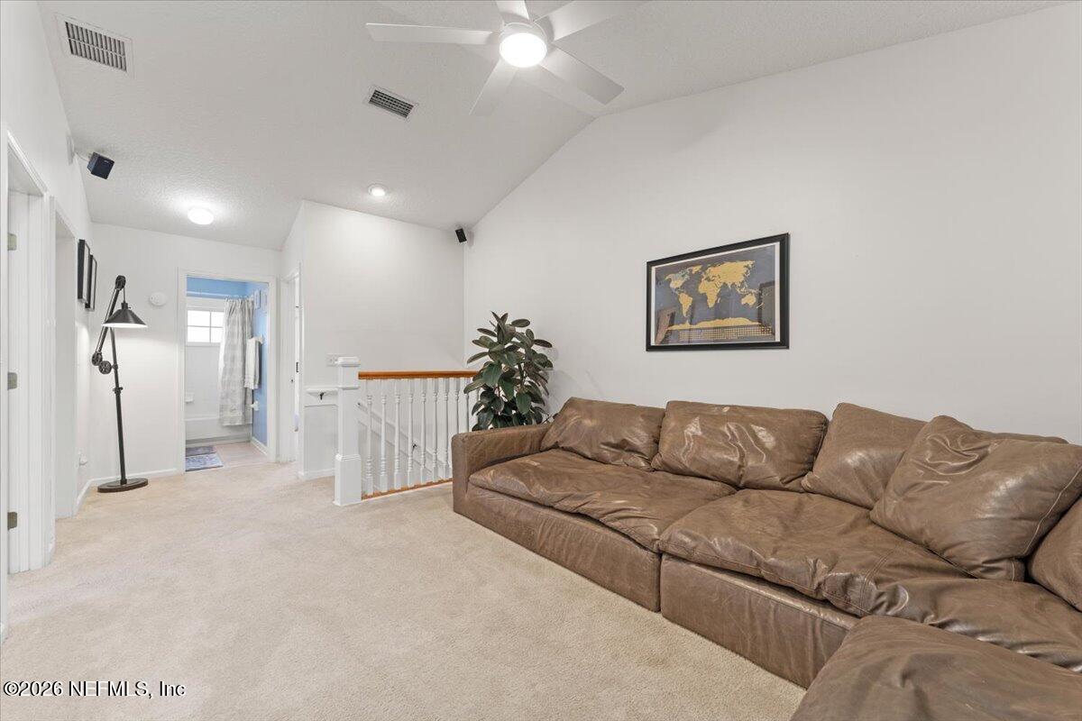 1489 Marshview Court Atlantic Beach, FL 32233 - Photo 26 of 47 a living room with furniture white walls and a chandelier
