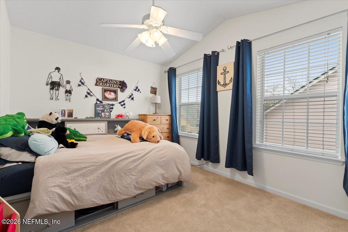 1489 Marshview Court Atlantic Beach, FL 32233 - Photo 33 of 47 a bedroom with a bed mirror and a large window
