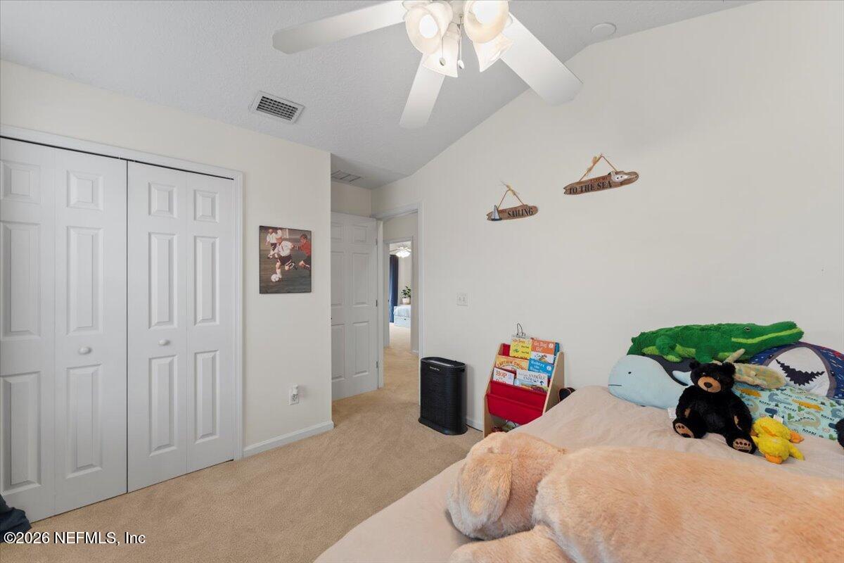 1489 Marshview Court Atlantic Beach, FL 32233 - Photo 34 of 47 a bedroom with a bed and a chandelier