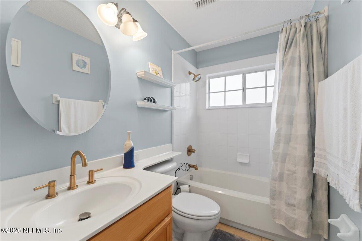 1489 Marshview Court Atlantic Beach, FL 32233 - Photo 35 of 47 a bathroom with a bathtub shower sink vanity mirror and toilet
