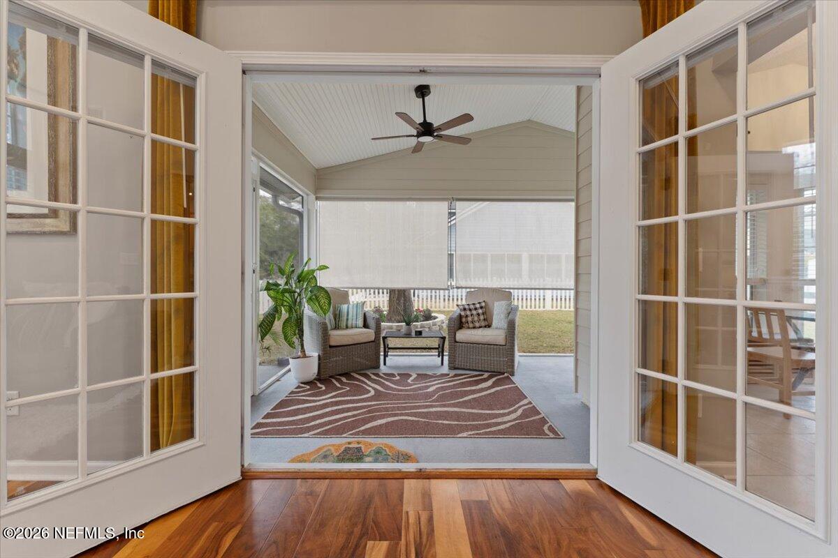 1489 Marshview Court Atlantic Beach, FL 32233 - Photo 36 of 47 a dining room with wooden floor and a floor to ceiling window