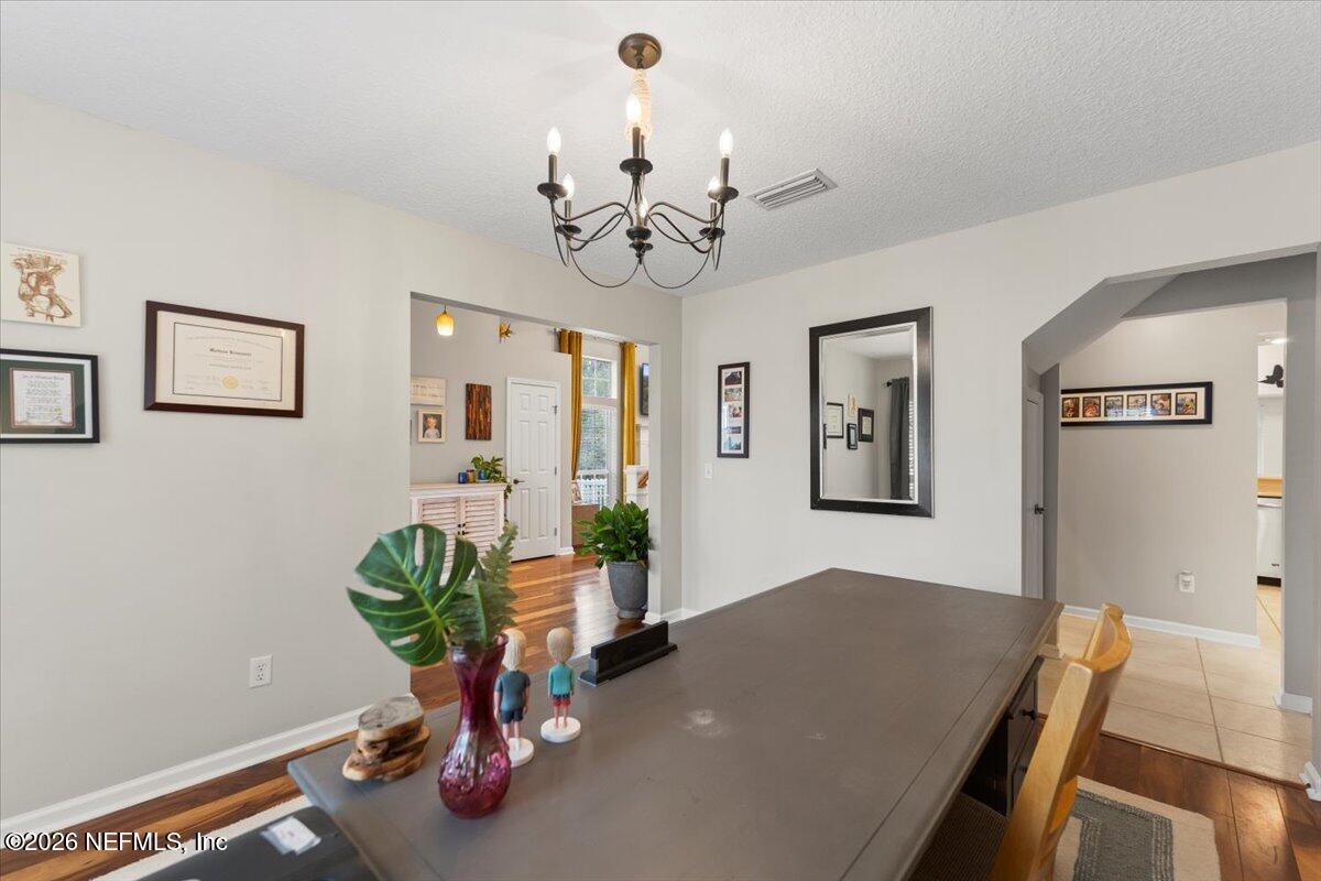 1489 Marshview Court Atlantic Beach, FL 32233 - Photo 6 of 47 a view of a dining room with furniture a chandelier and wooden floor