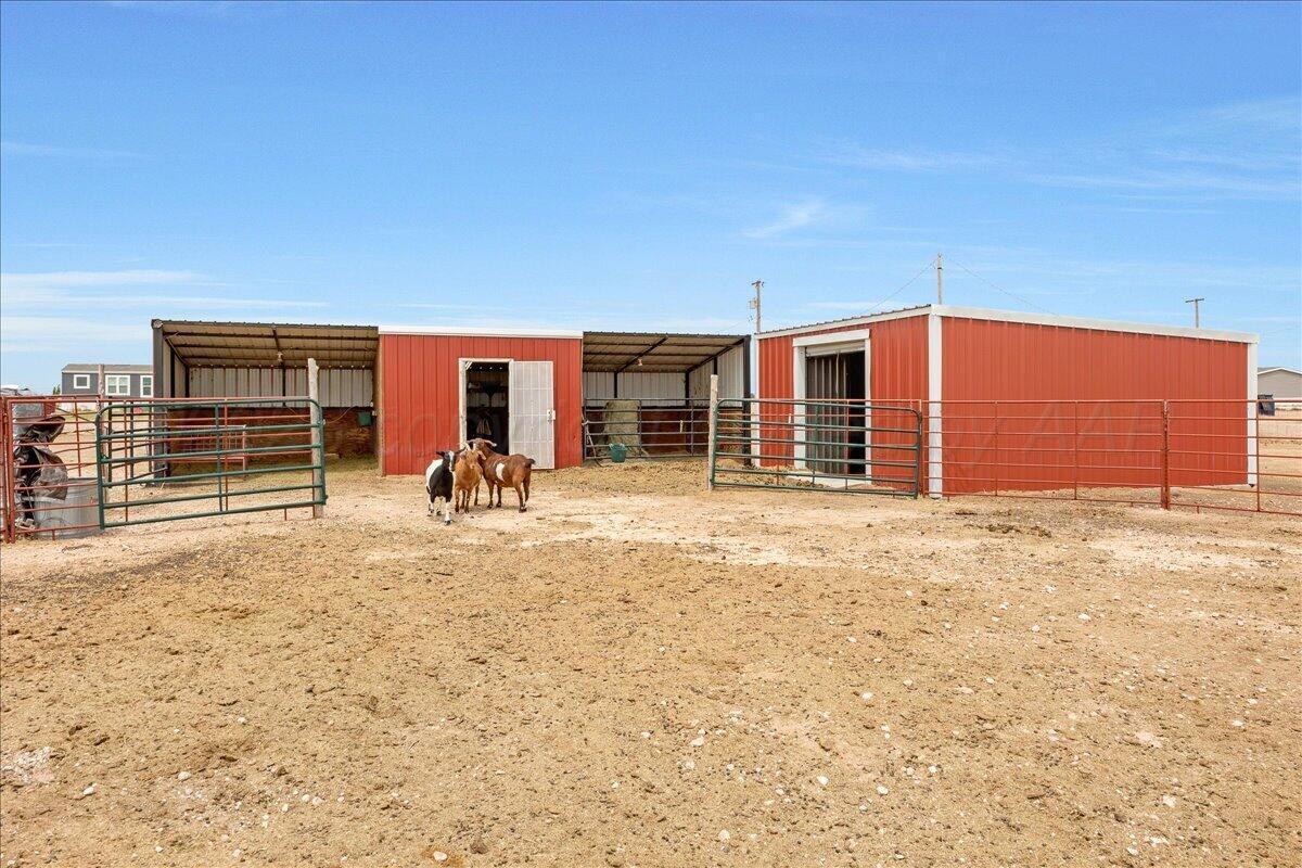 10551 Anderson Road Amarillo, TX 79118 - Photo 17 of 28 a view of a house with a backyard and chair