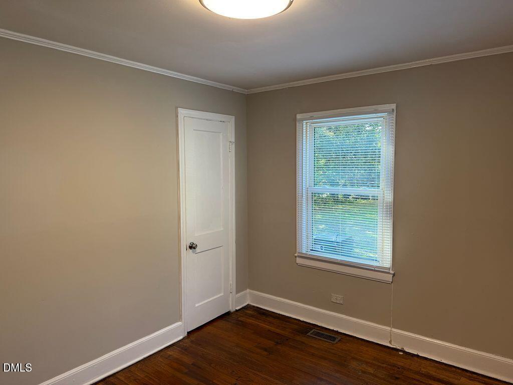 619 Old Oxford Road Durham, NC 27704 - Photo 13 of 22 a view of an empty room with wooden floor and a window