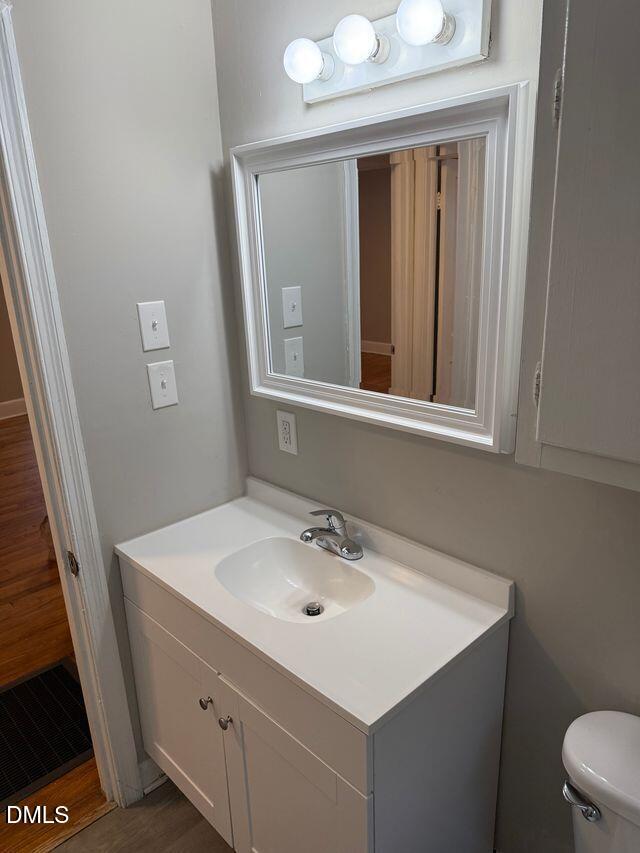 619 Old Oxford Road Durham, NC 27704 - Photo 16 of 22 a bathroom with a sink mirror and a toilet