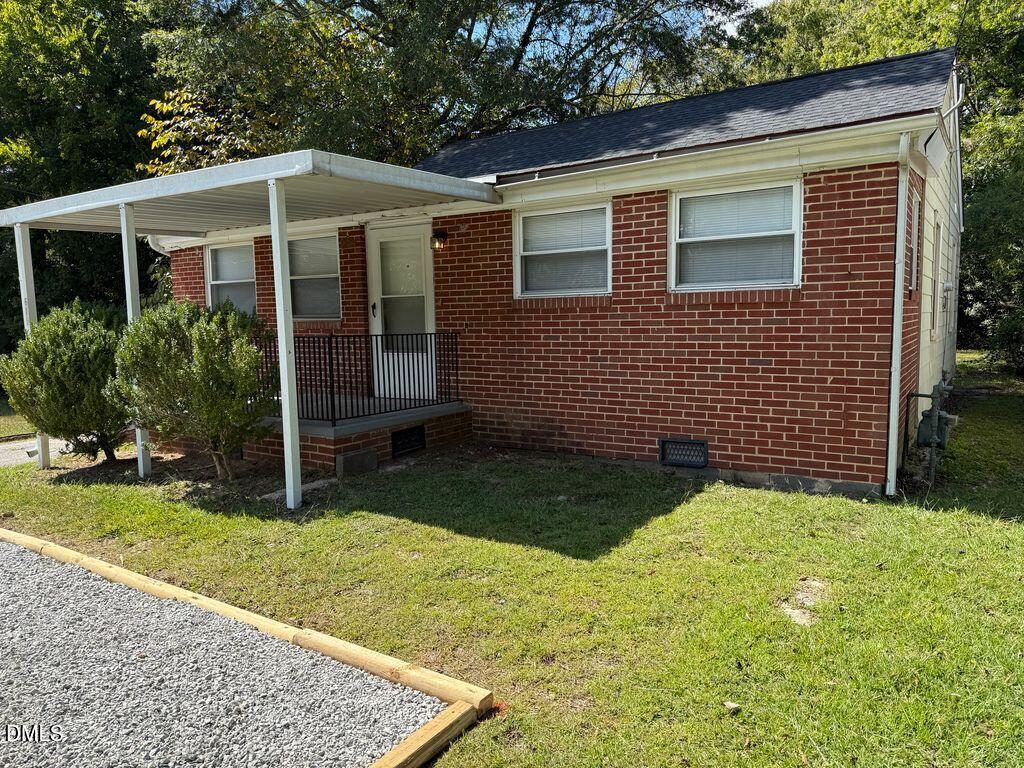 619 Old Oxford Road Durham, NC 27704 - Photo 3 of 22 a front view of a house with garden