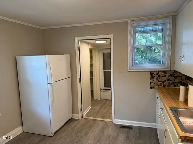 a kitchen with a refrigerator and a stove