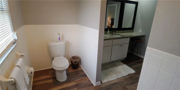 a kitchen with a table chairs refrigerator and a window