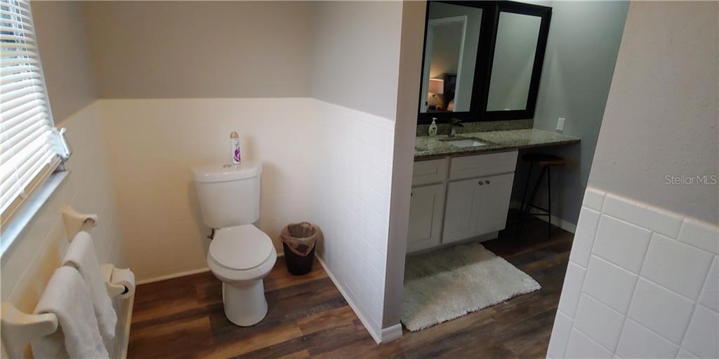 309 Shore T Road Nokomis, FL 34275 - Photo 11 of 42 a bathroom with a granite countertop sink and a toilet