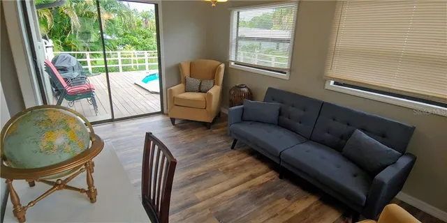 a kitchen with stainless steel appliances granite countertop a sink a stove and wooden floor