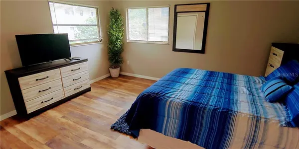 a bedroom with a bed and a mirror