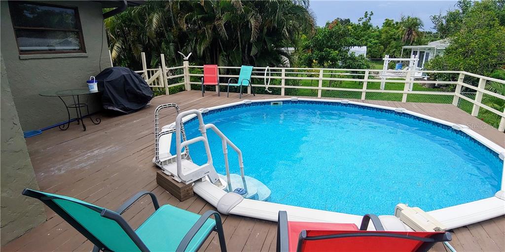309 Shore T Road Nokomis, FL 34275 - Photo 4 of 42 a view of a chairs and table on the roof deck