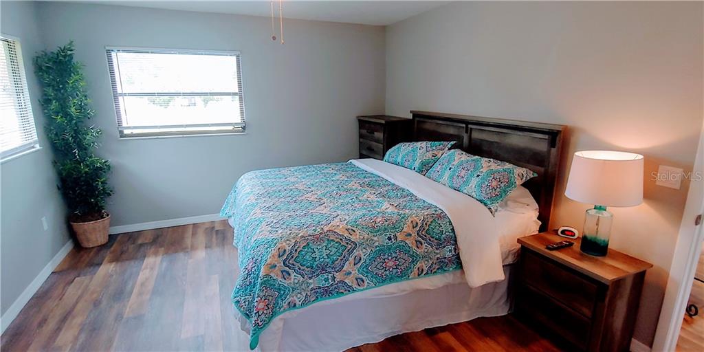 309 Shore T Road Nokomis, FL 34275 - Photo 8 of 42 a bedroom with a bed and wooden floor