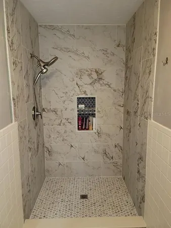 a bathroom with a granite countertop sink and a toilet