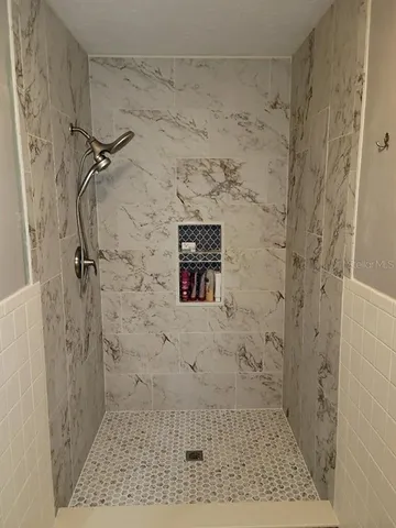 a bathroom with a granite countertop sink and a toilet