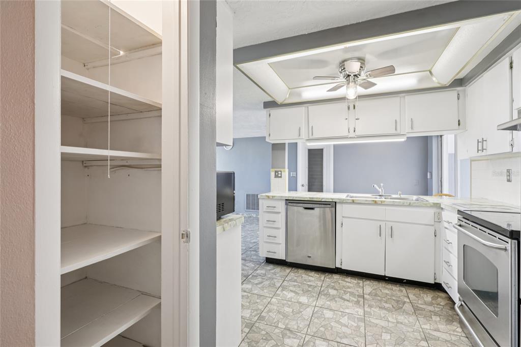 3548 Darlington Road Holiday, FL 34691 - Photo 15 of 32 a kitchen with white cabinets and white appliances