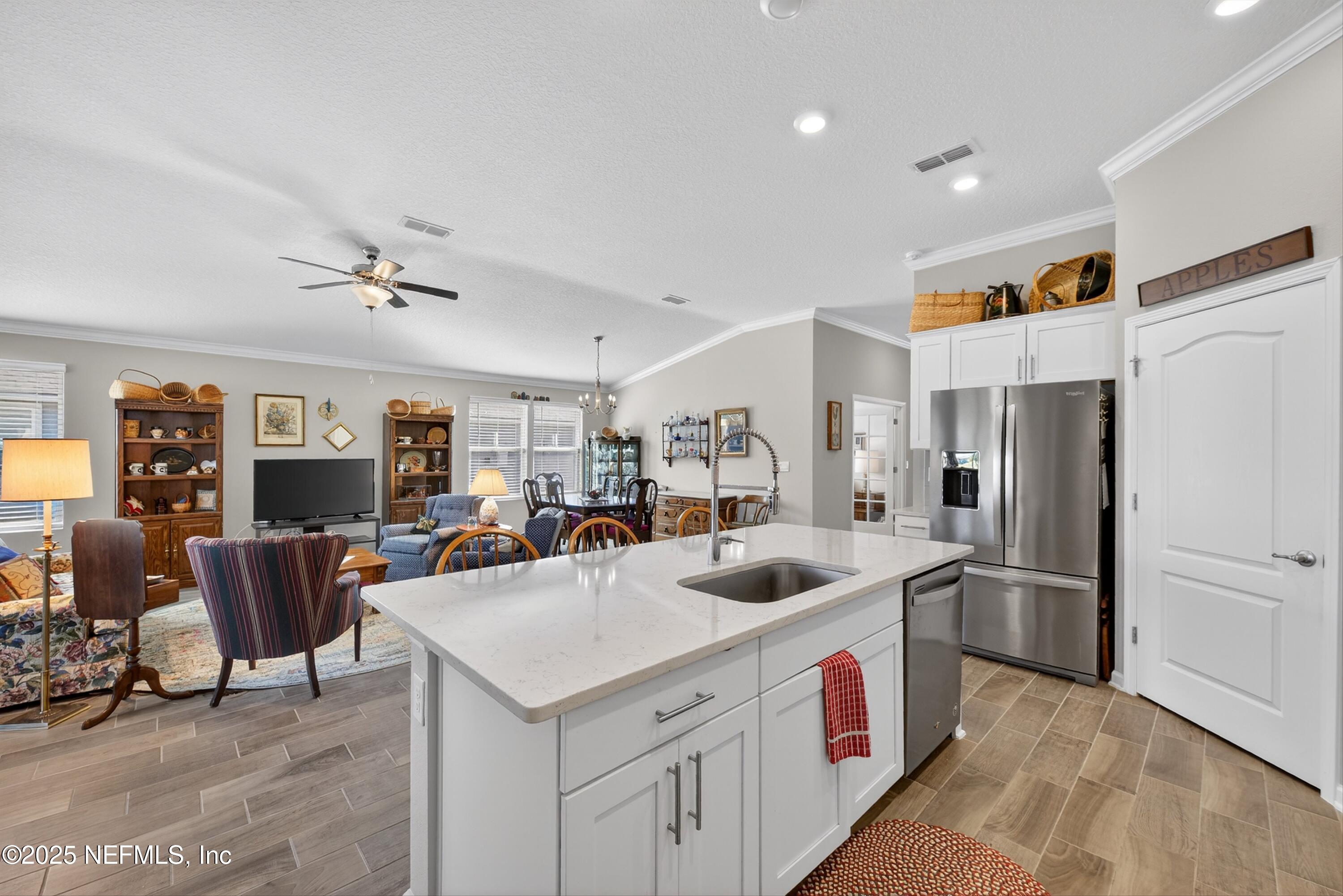 70 Spoonbill Circle St. Augustine, FL 32095 - Photo 12 of 76 a kitchen that has a lot of cabinets stainless steel appliances and a center island