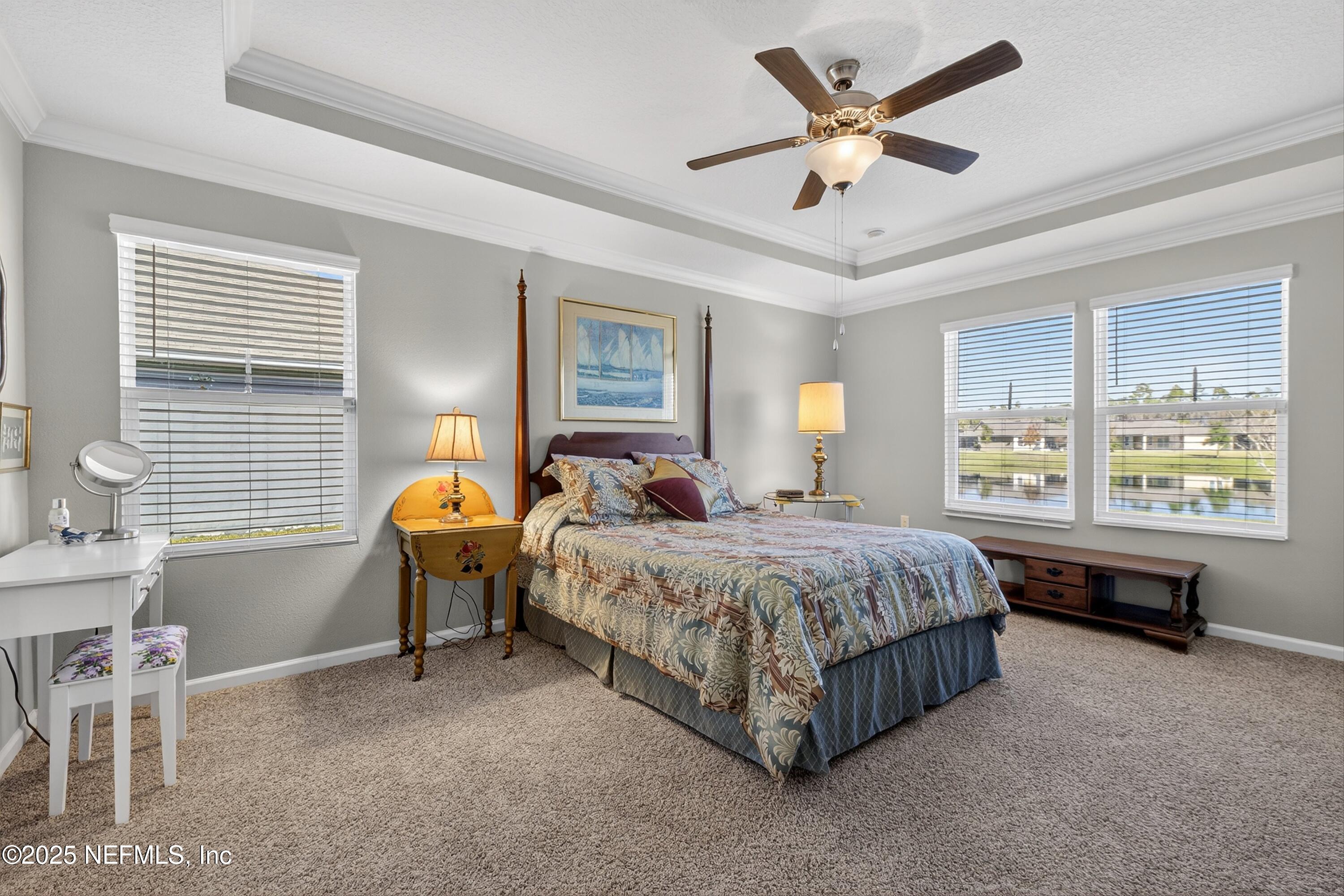 70 Spoonbill Circle St. Augustine, FL 32095 - Photo 18 of 76 a spacious bedroom with a bed and a chandelier