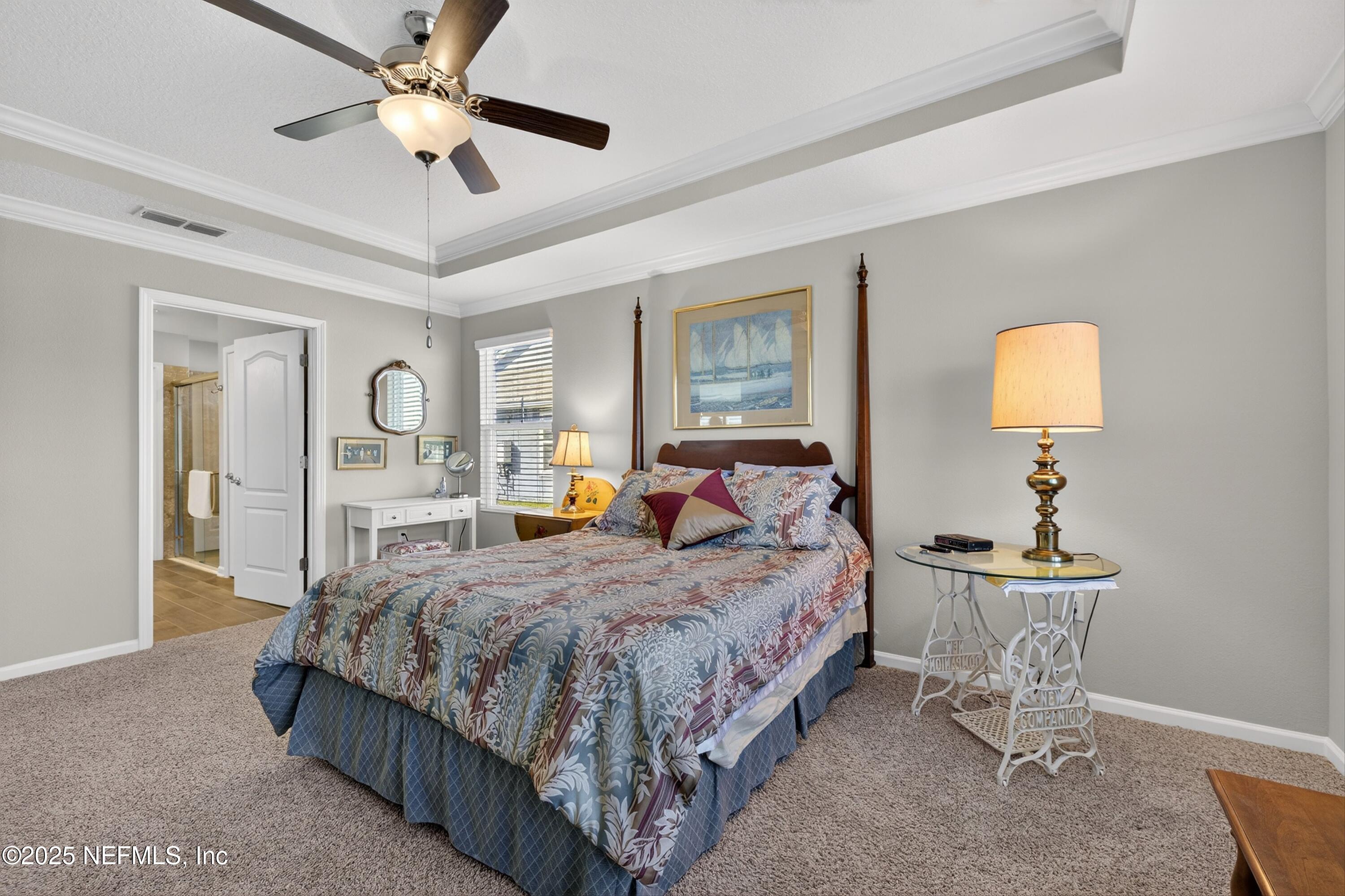 70 Spoonbill Circle St. Augustine, FL 32095 - Photo 20 of 76 a bedroom with a bed and a chandelier