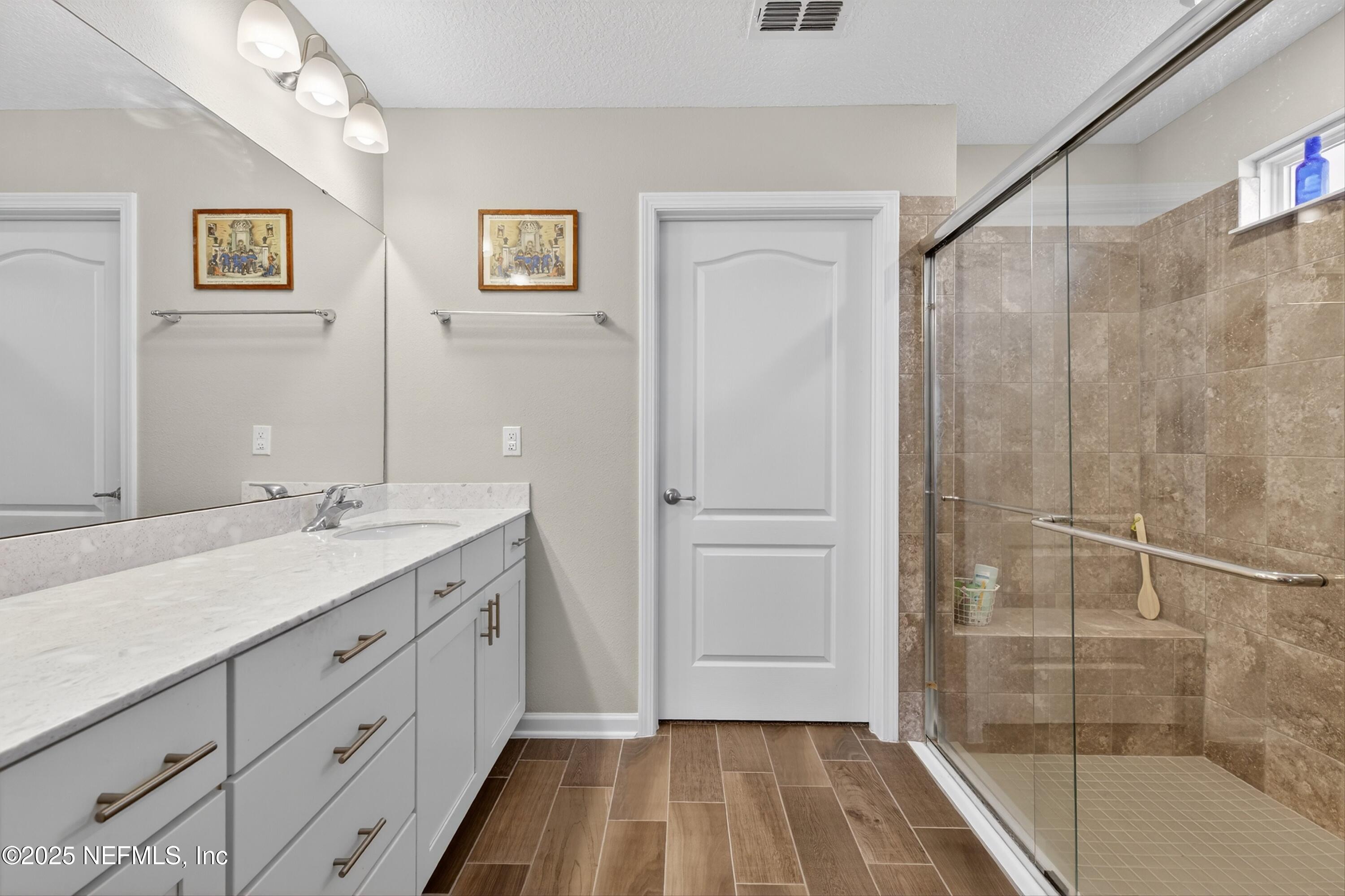 70 Spoonbill Circle St. Augustine, FL 32095 - Photo 22 of 76 a spacious bathroom with a shower sink and mirror