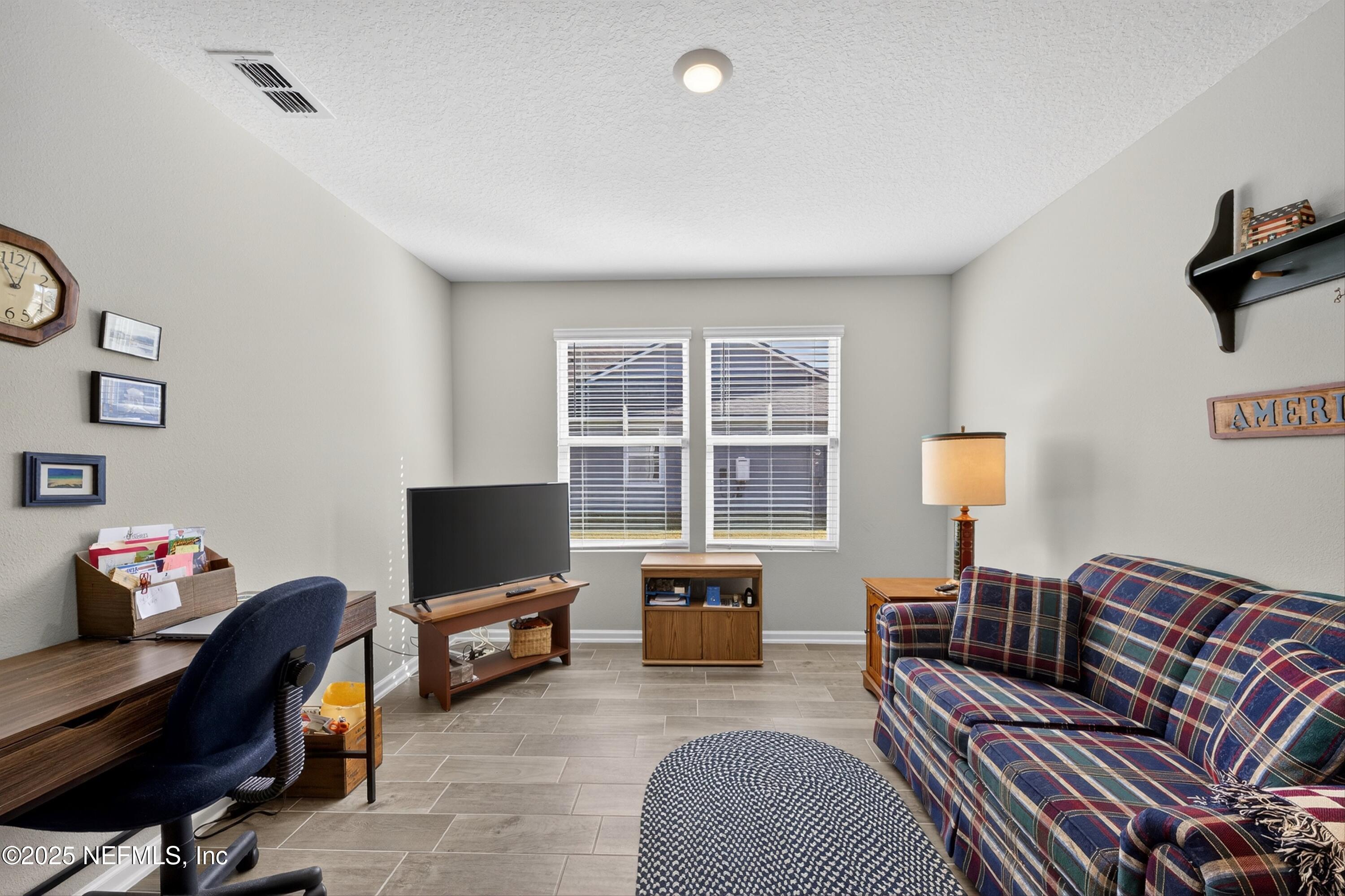 70 Spoonbill Circle St. Augustine, FL 32095 - Photo 27 of 76 a living room with furniture a flat screen tv and a window