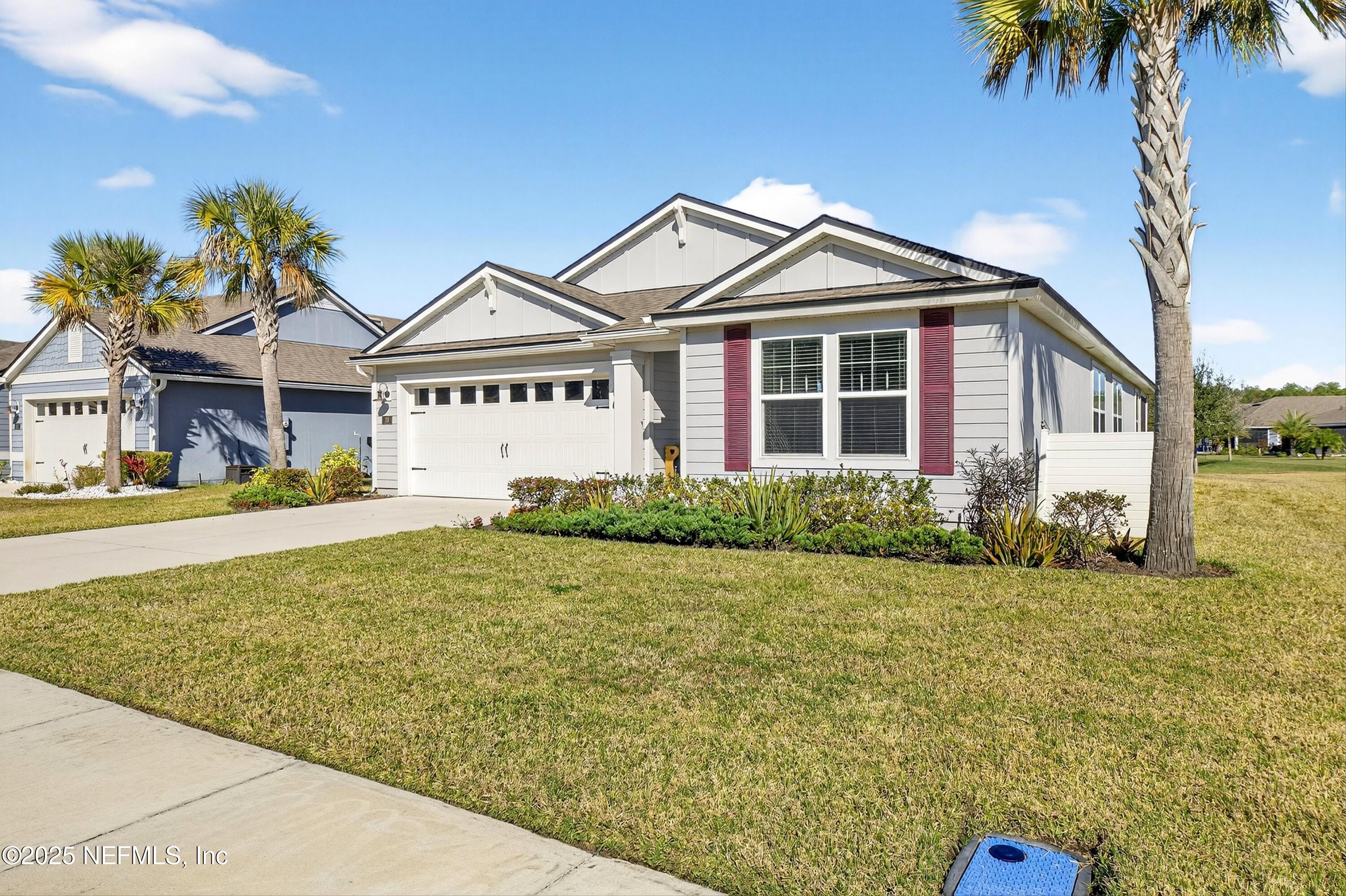 70 Spoonbill Circle St. Augustine, FL 32095 - Photo 3 of 76 a front view of a house with a garden and yard