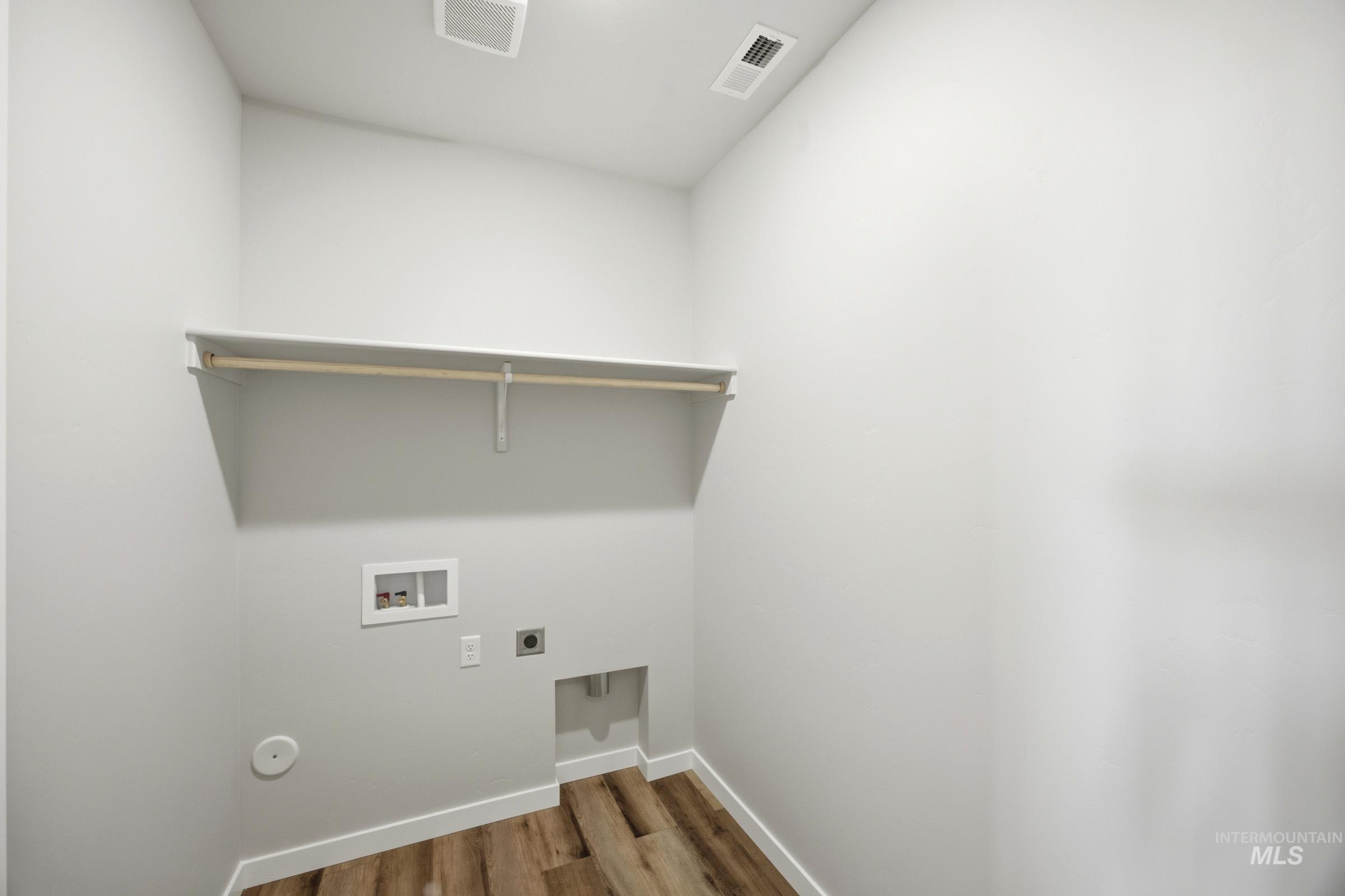 4344 East Rincon Drive Meridian, ID 83642 - Photo 20 of 26 Dedicated utility area featuring a wood-finish flooring, built-in shelving, and laundry hookups