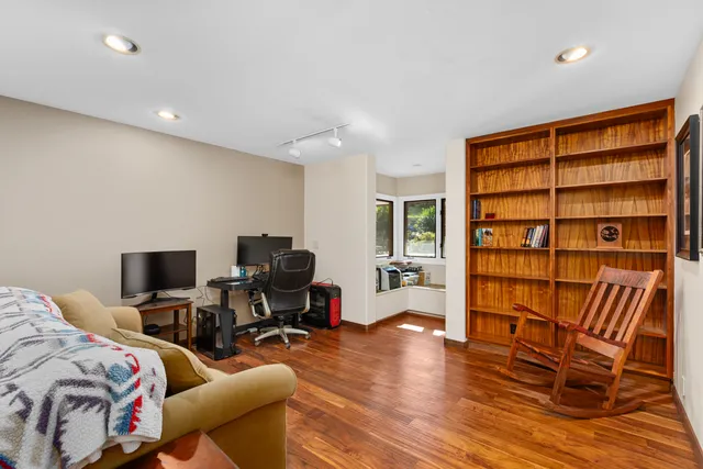 a view of a livingroom with workspace and a couch