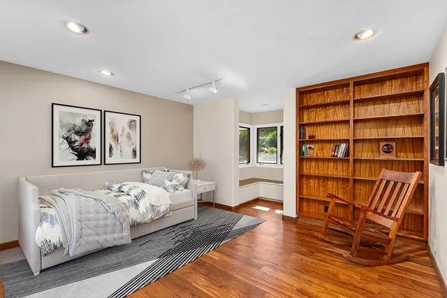 a bedroom with furniture and a wooden floor