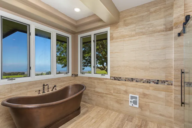 a bath tub sitting in a bathroom next to a window